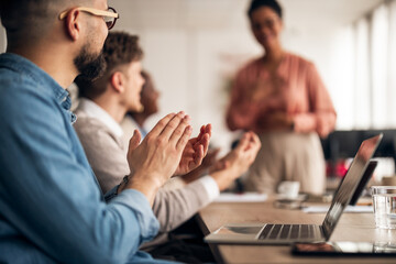Professionals Applauding Speaker During a Team Meeting in an Office Environment