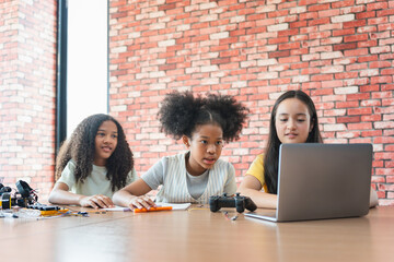 Young Girls Engaged in Robotics and STEM Learning, Diverse Kids Building a Robot Arm in a Science...