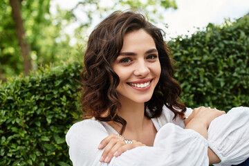 Joyful summer afternoon with a young woman enjoying nature and sunshine in the park