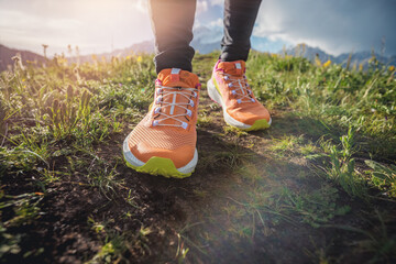Trail runner running on the high altitude grassland mountain top trail
