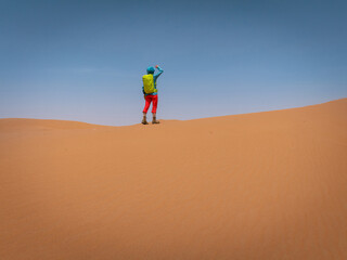Backpacking woman hiking  in the desert
