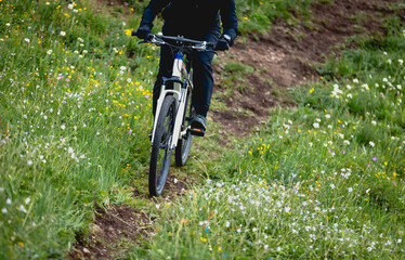 Riding mountain bike on grassland forest mountains