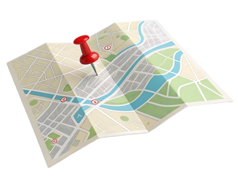 A folded map with streets parks and a river marked by a red pin indicating a specific location