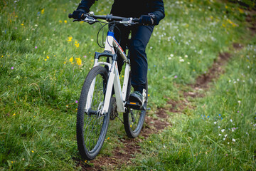 Riding mountain bike on grassland forest mountains