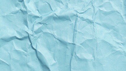 Abstract crumpled blue paper background with wavy surface texture. Crumpled blue vintage paper surface texture for background. Wrinkled paper background with copy space for text.
