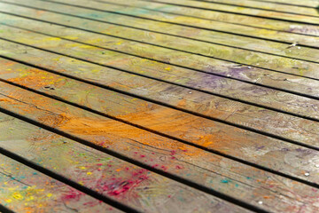 Colorful powder covering wooden planks creating vibrant holi festival background