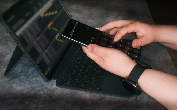 Closed up young woman read and write reports figure paper charts. Professional accountant calculating annual balance and report finance.