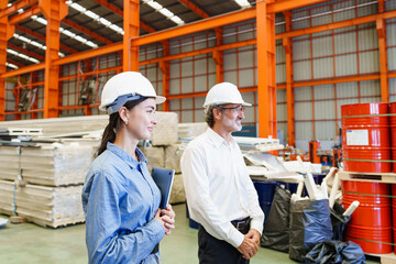 Professional conversation between supervisor and worker in sheet metal facility, emphasizing...