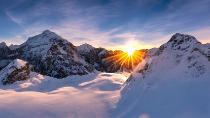 Panoramic sunrise over snowy mountain peaks and a misty alpine landscape