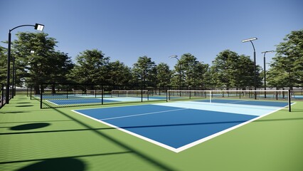 corner view of  empty pickleball courts with wire fence and floodlights around it