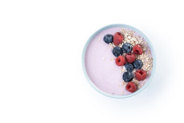 Healthy smoothie bowl with berries isolated on white background. Top view. Copy space