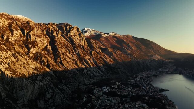 Aerial view of Boka kotor bay with cities Ljuta and Dobrota and Kotor and mountains at sunset in Montenegro