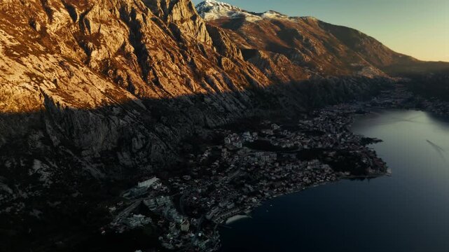 Aerial view of Boka kotor bay with cities Ljuta and Dobrota and Kotor and mountains at sunset in Montenegro