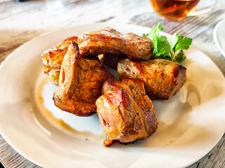 Juicy grilled meat served on a plate with fresh herbs in a cozy dining setting