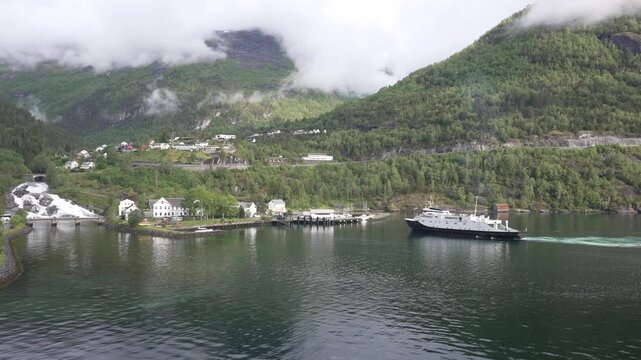 Aerial view of Hellesylt waterfall and ferry arriving in Hellesylt with mountains in background, Sunnylvsfjorden, Stranda Municipality, Norway, Scandinavia, Europe