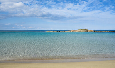 Empty sandy tropical exotic beach with golden sand and remote island.