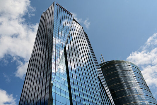 Warsaw, Poland, Europe : The Bridge innovative skyscaper (known also as Bellona Tower) with Santander Bank headquarters, logo on the top, Warsaw Spire at right, view from Towarowa street
