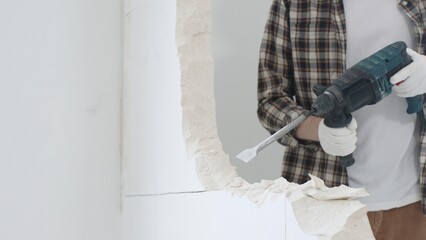 Close up of unrecognizable male construction worker wearing beige checkered shirt and protective...