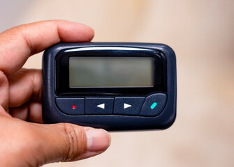 Hand holding One way isolated pager white background with an empty space  blank screen for inscription