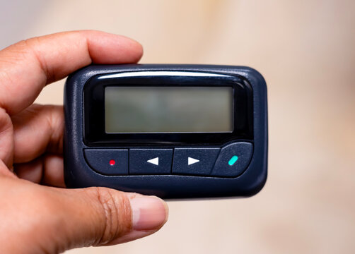 Hand holding One way isolated pager white background with an empty space  blank screen for inscription