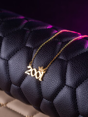 Close-up of a metallic gold pendant in the shape of 