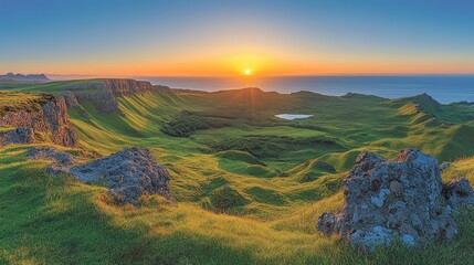Sunrise over a dramatic, grassy valley with cliffs and rocks