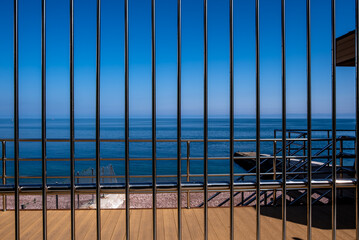 An iron fence made of twigs on the seashore.
