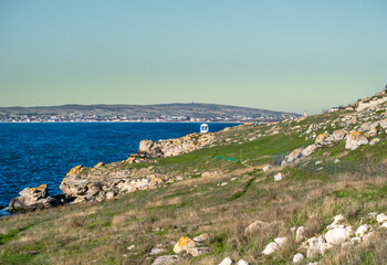 View of a small gazebo on the rocks by the sea.