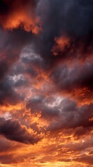 Fototapeta premium Fiery sunset illuminating cloudscape with orange and red tones, creating a dramatic and vibrant atmosphere