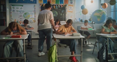Elementary School Students Sitting and Writing Exam on Renewable Energy Resources in Modern...