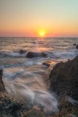 Ocean Sunset with Rocks and Waves