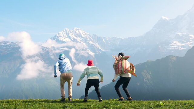 Three men show their strong arms in a powerful pose on a mountain in Manali, Himachal Pradesh, India.