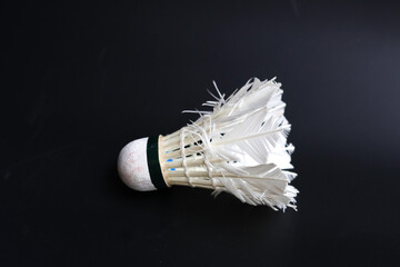 Close up view of shuttlecock used in badminton, showcasing its intricate feather design and cork...