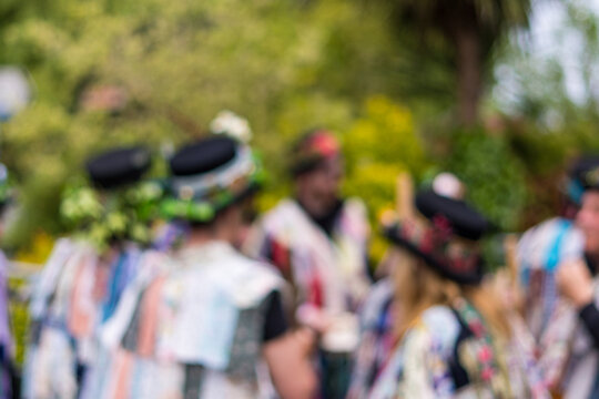 Morris dancers in the street, Worcestershire, UK. Celebrating the May Day Bank Holiday. With a blurred edit