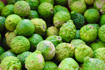 Kafir limes are vibrant green citrus fruits known for their bumpy texture and aromatic leaves. They are often used in cooking and traditional remedies, adding unique flavor to dishes