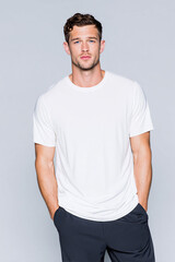 Obraz premium A beautiful male model wearing a large white t-shirt. A product shot for fashion and apparel. best use for mockup.
