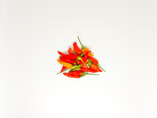 Fresh red chilies with green stems, isolated on a clean white background, symbolize spice and...
