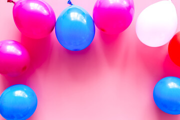 Decorative frame with colorful balloons on pink background top-down frame copy space