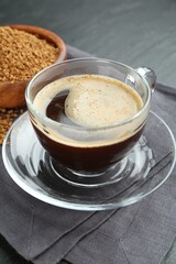 Aromatic instant coffee on black table, closeup