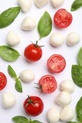 Tasty mozzarella cheese balls, tomatoes, basil and peppercorns on white background, flat lay
