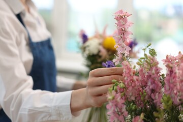 Fototapeta premium Florist making bouquet of flowers in shop, closeup