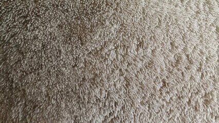 Macro photo of soft, white terrycloth towel texture. A cozy, clean fabric background.