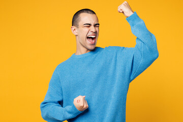 Young middle eastern man wearing blue sweatshirt casual clothes doing winner gesture celebrate...