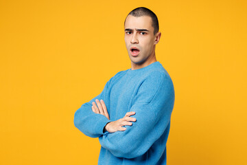 Side view young sad mad middle eastern man he wear blue sweatshirt casual clothes hold hands...