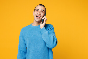 Young middle eastern man wearing blue sweatshirt casual clothes talk speak on mobile cell phone...