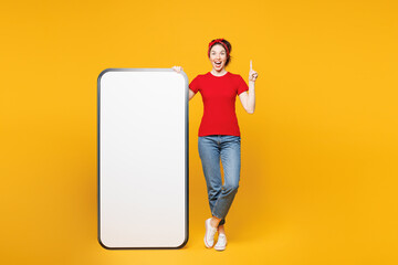 Full body young smart woman wear red t-shirt casual clothes big huge blank screen mobile cell phone...