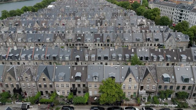 Aerial tilt up shot of Kartoffelr&aelig;kkerne (English: The Potato Rows), a historic residential area in Copenhagen, Denmark, known for its distinctive rows of 19th-century terraced houses.	
