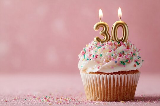 Single cupcake with lit 30 candles and colorful sprinkles sits on a pink glittery surface, celebrating a milestone birthday or anniversary