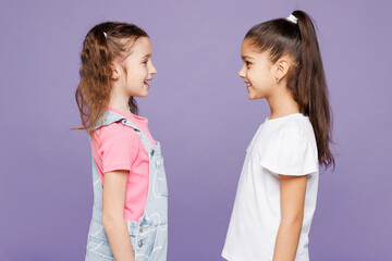 Side profile view smiling cheerful cool fun little two friends kids children girls 9-10 years old...