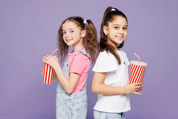 Side view little two friends kids children girls 9-10 years old wear casual clothes together drink...